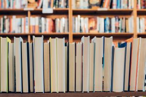 Stack of books on shelf in library